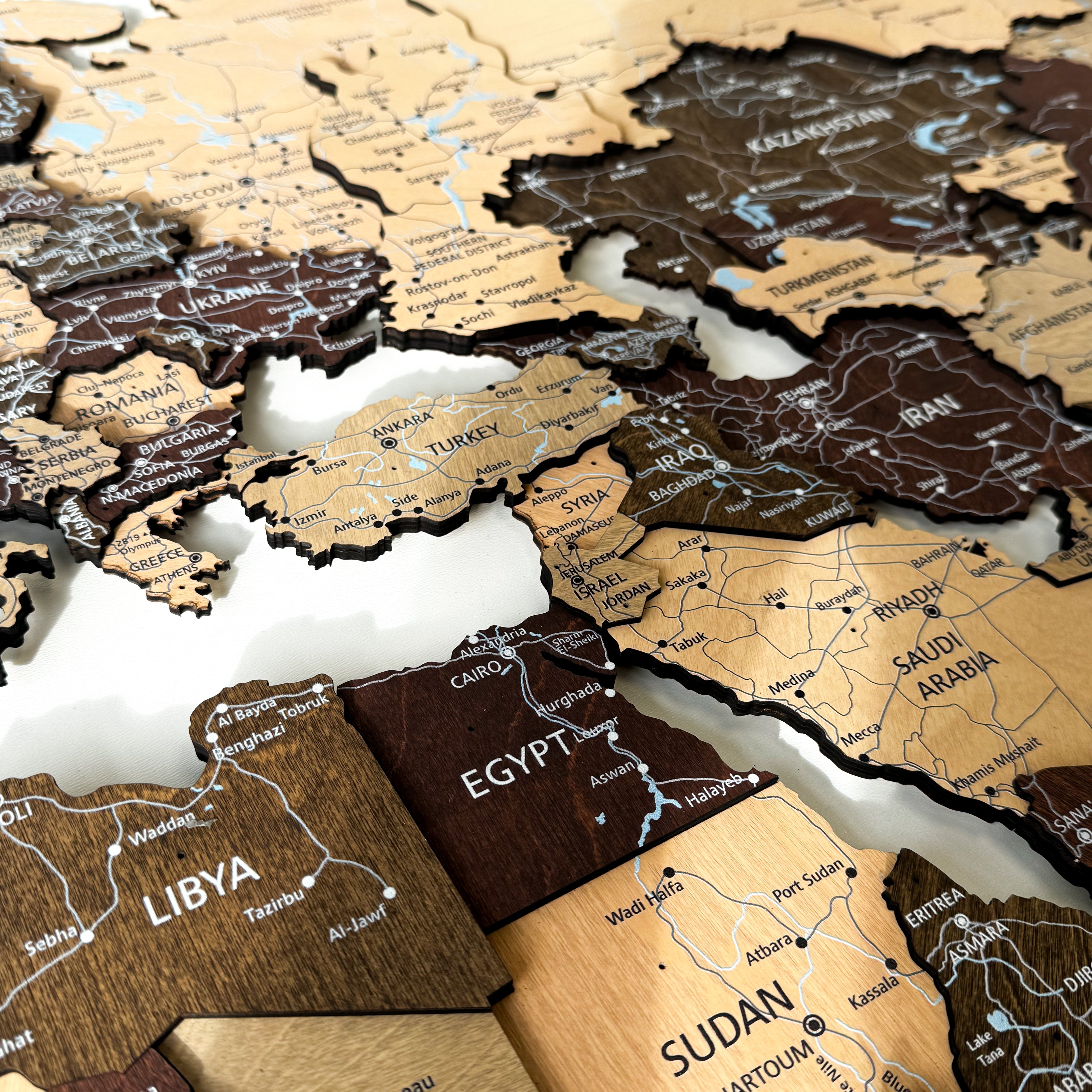 Detailed premium wooden world map with 3D layers and UV printed cities, rivers, and islands