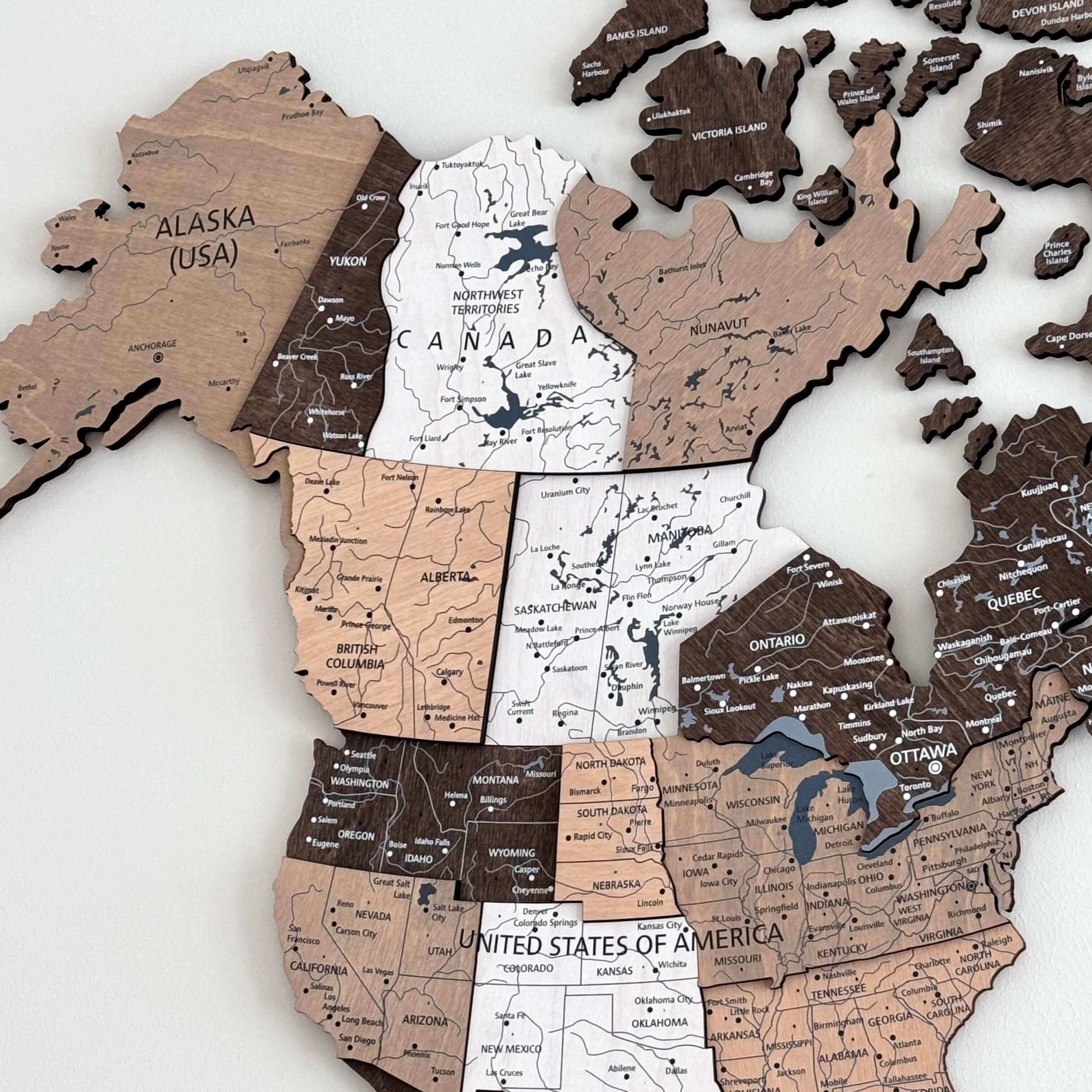 3D wood world map in light brown showing detailed regions of Canada and the United States, crafted with natural wood.