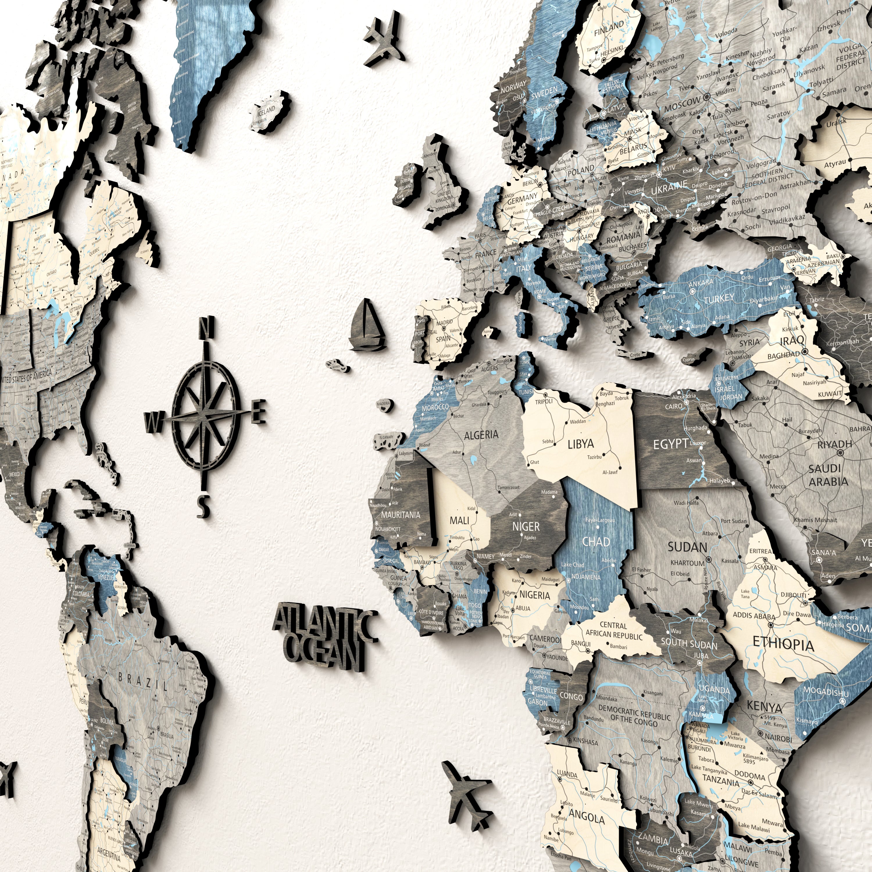 Close-up of the Nordique 3D wooden world map showcasing continents and location labels, emphasizing details and texture.