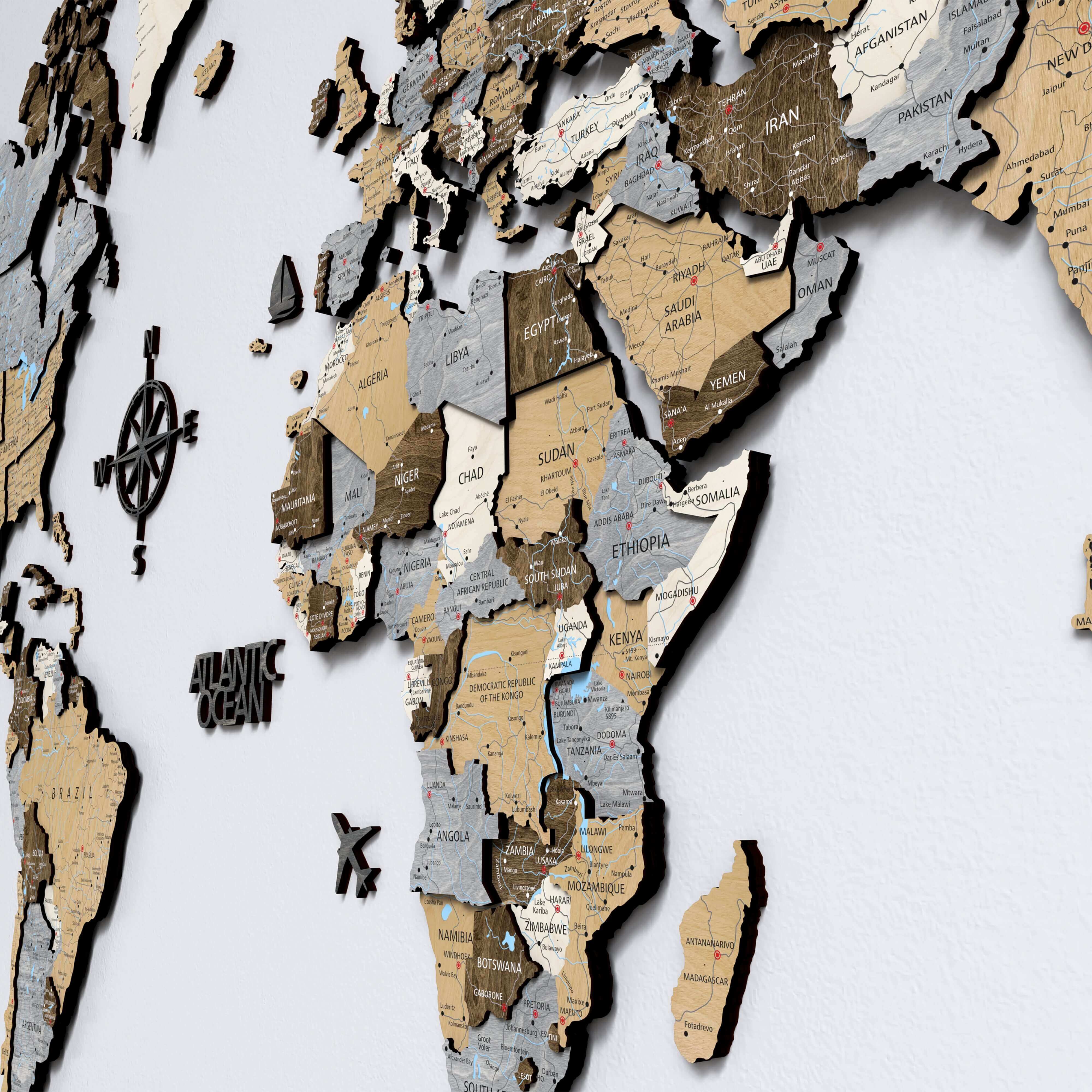 Wood World Map - Light Walnut with detailed countries and oceans illustrated on a wall.