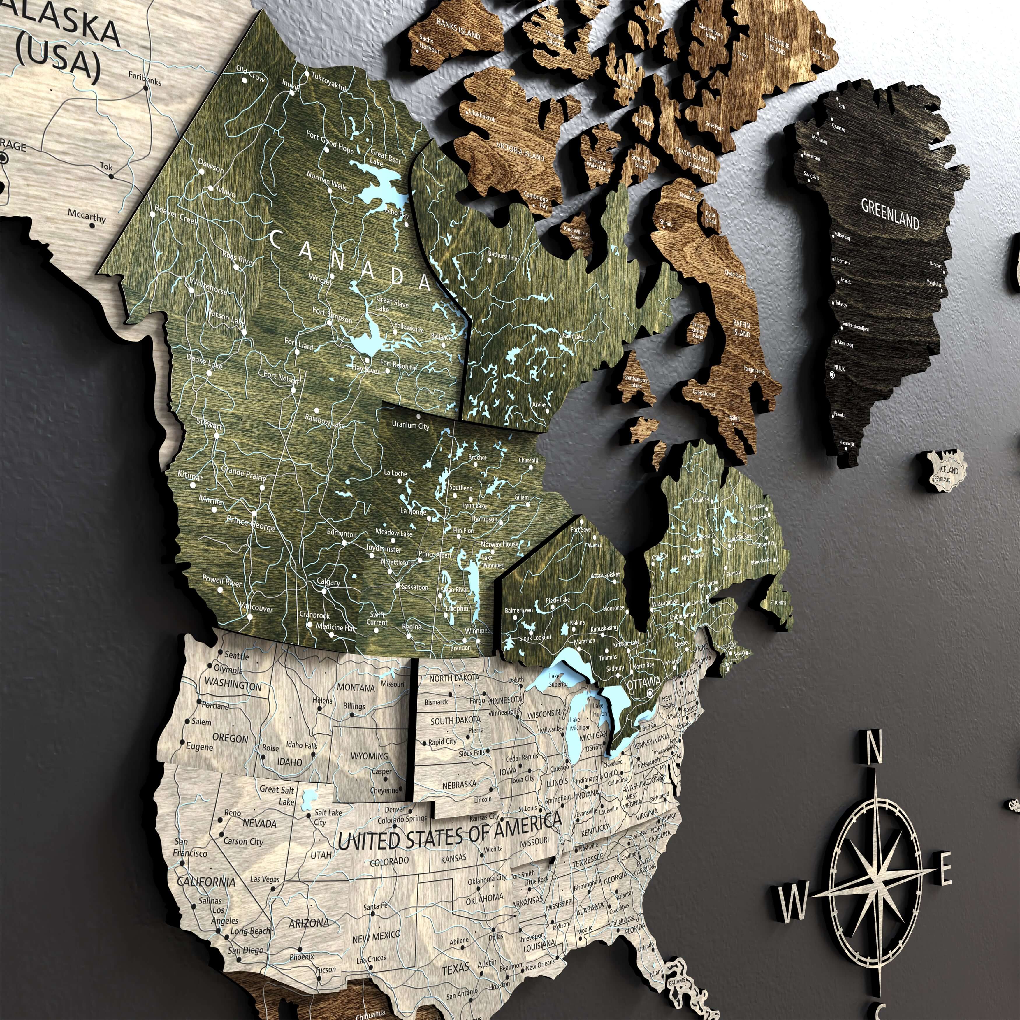 Close-up of 3D wooden world map showing detailed laser engraving of North America.