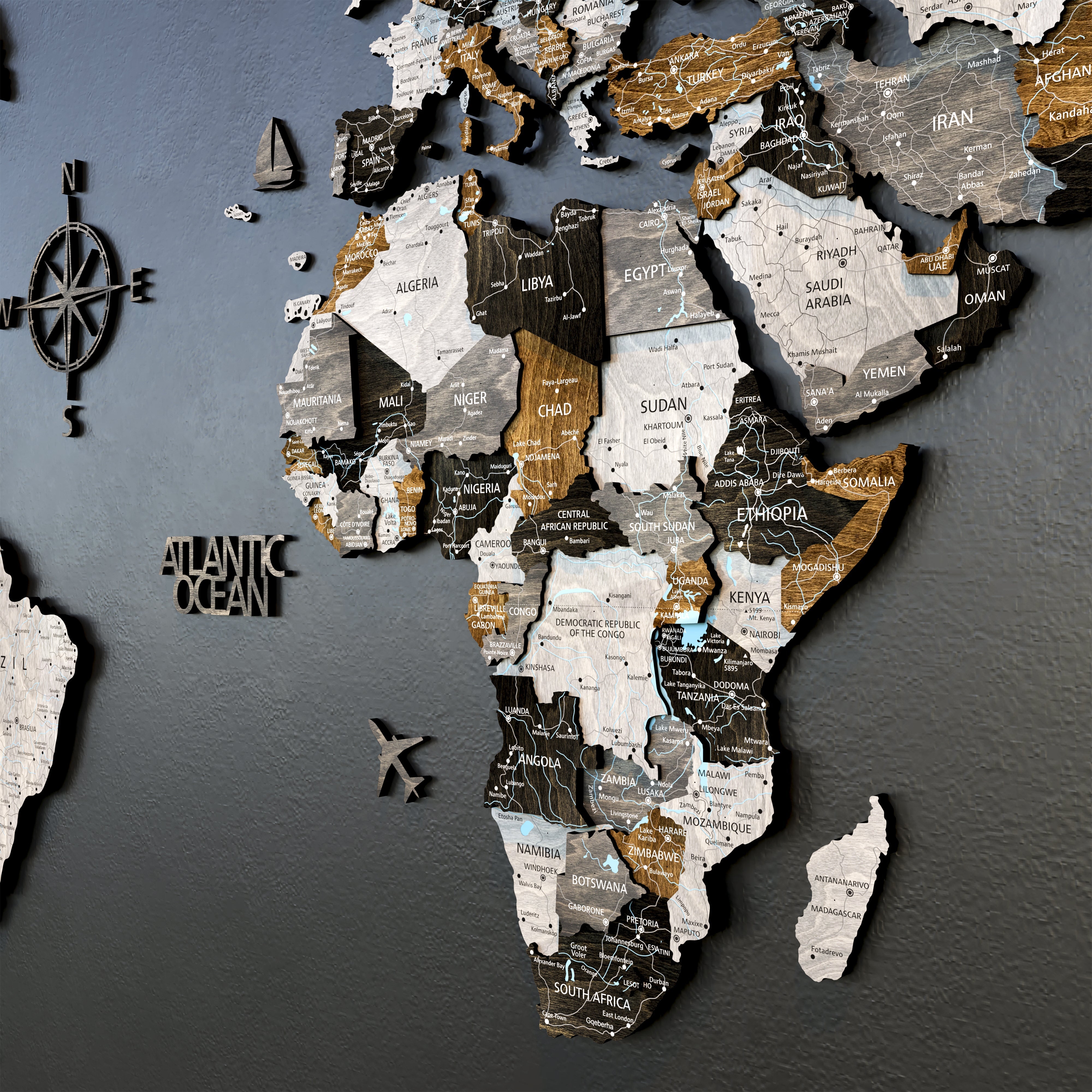 3D wooden world map in loft style featuring detailed African countries and ocean labels, mounted on a dark wall.