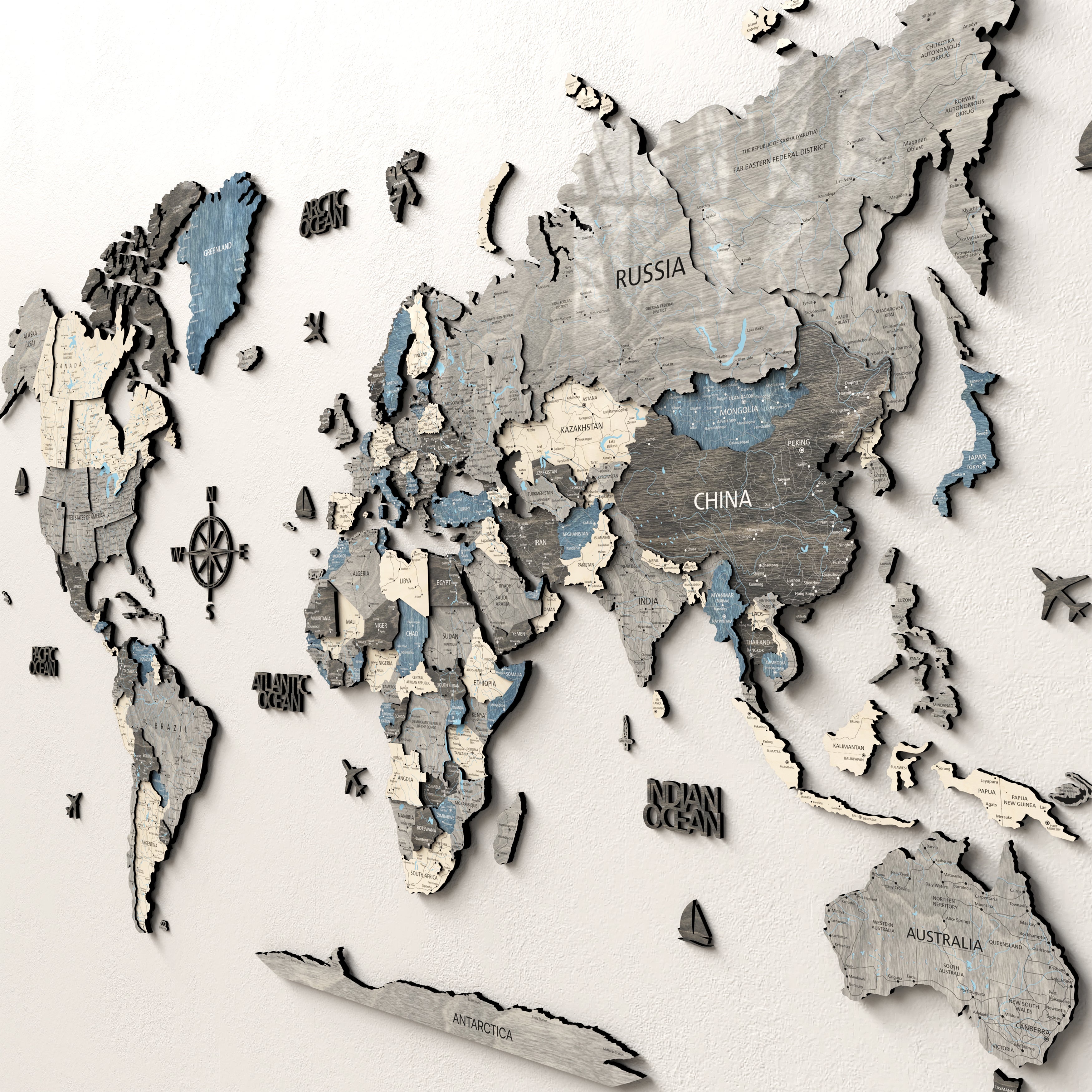 3D wooden world map showcasing intricately layered continents and countries on a textured surface.