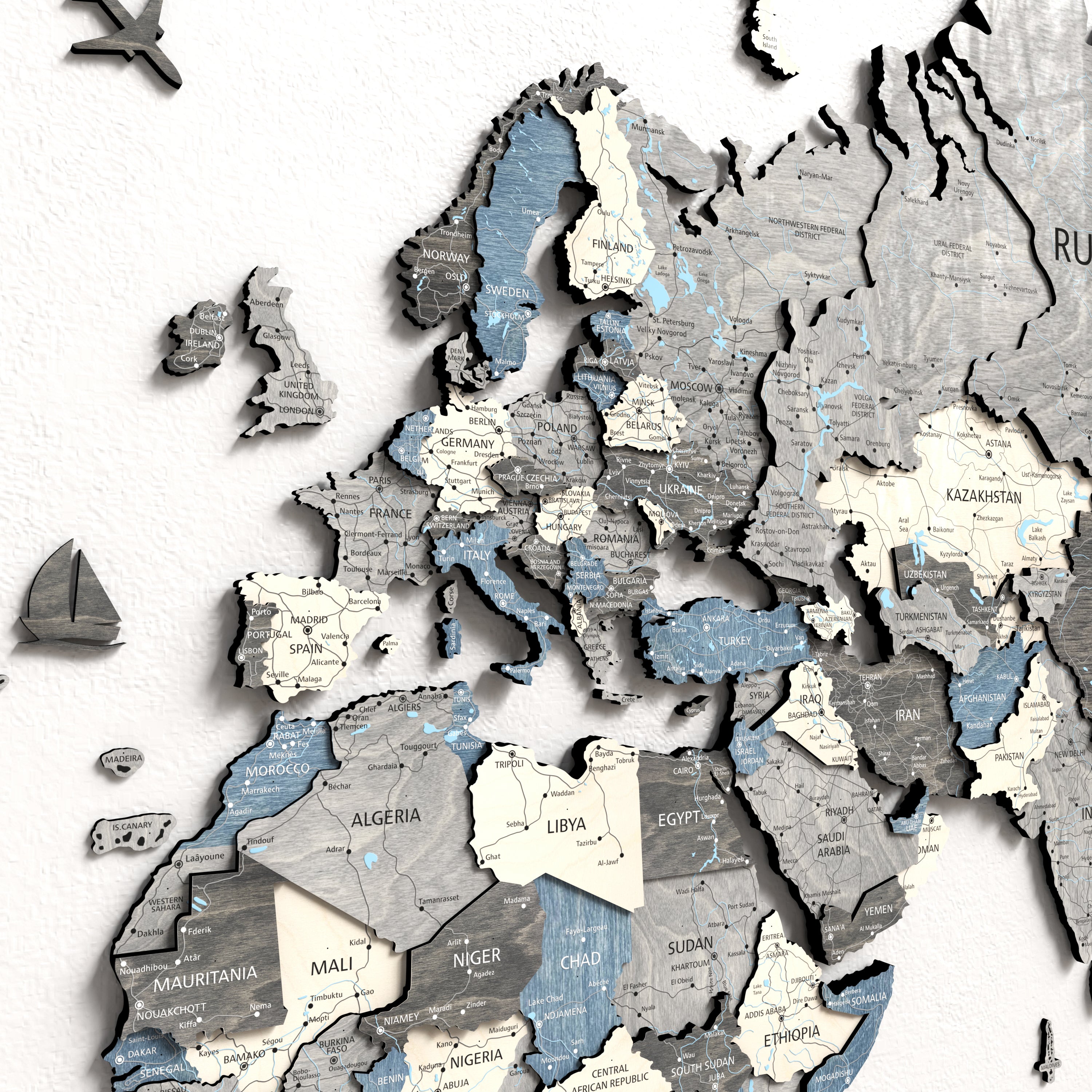 Close-up of a 3D wooden world map showcasing detailed countries and continents in neutral tones.