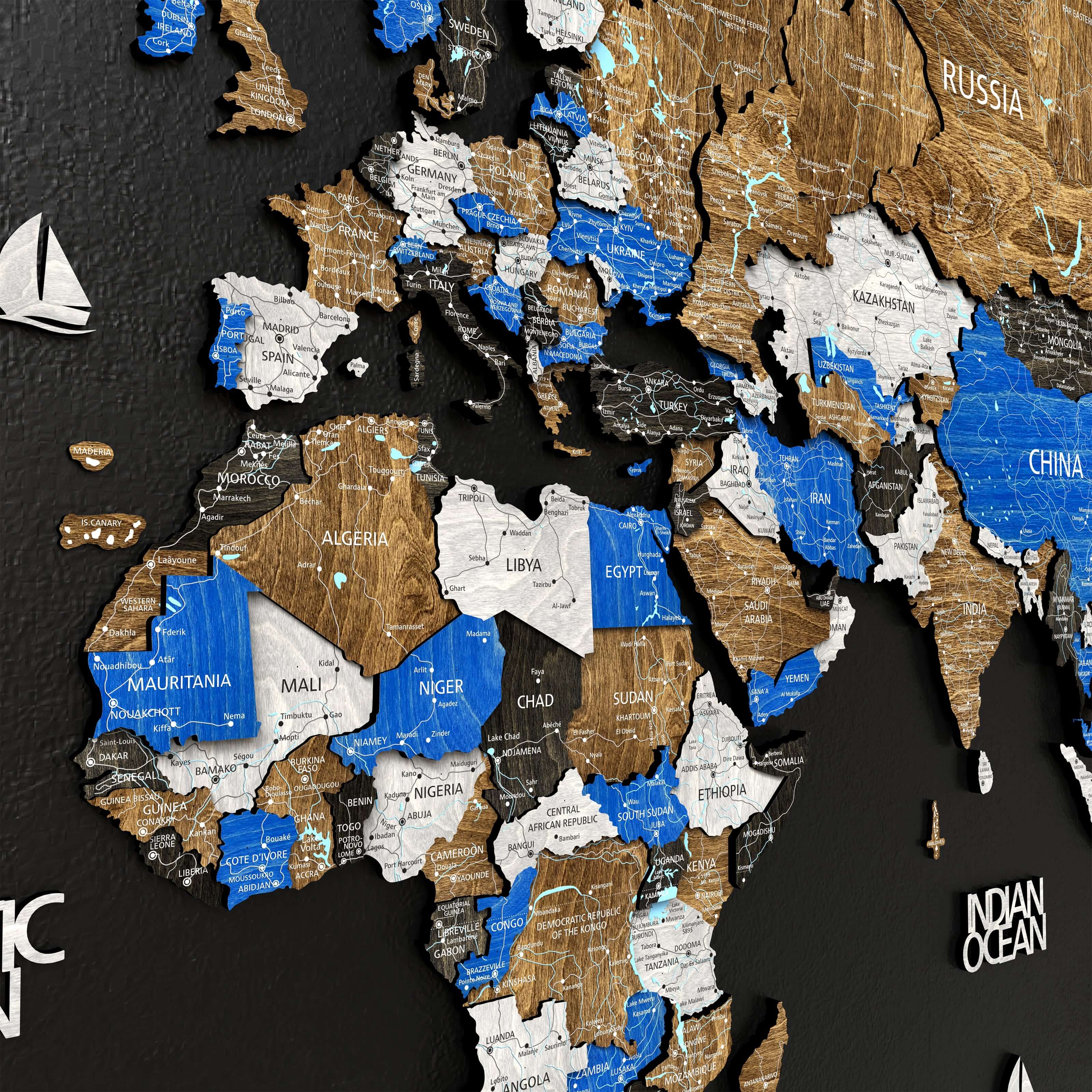 3D wooden world map highlighting countries and oceans in blue and beige finishes, showcasing intricate detailing.