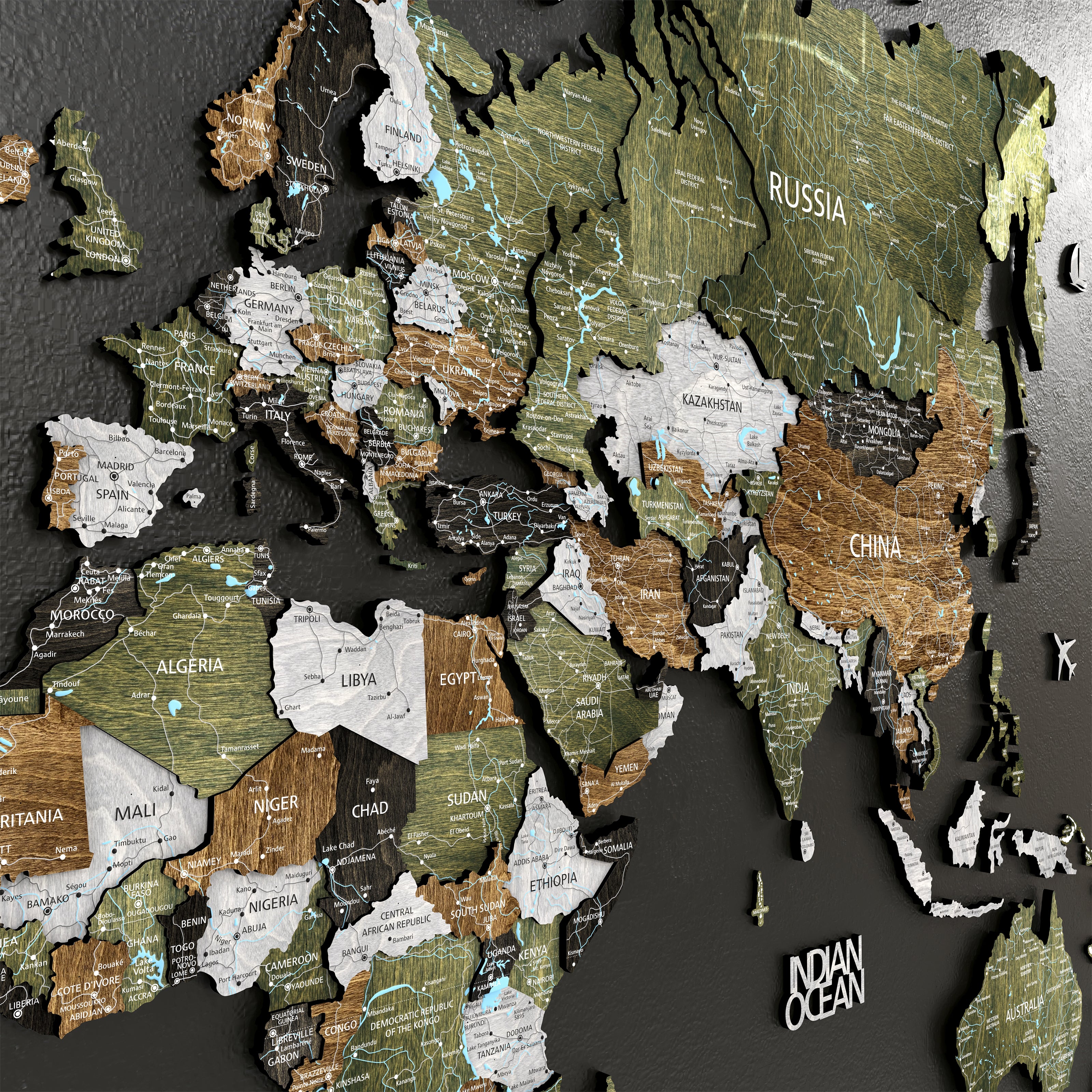 3D Wooden world map featuring intricate details of countries across Asia and Europe on a dark wall background.