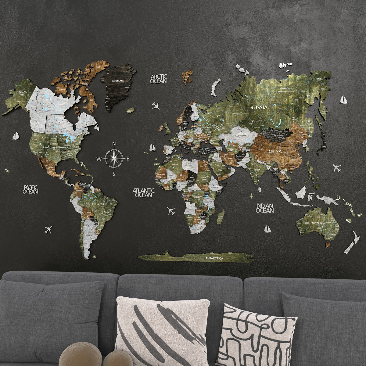 3D Wooden world map wall art in Woodland colors displayed on a black wall above a modern sofa.
