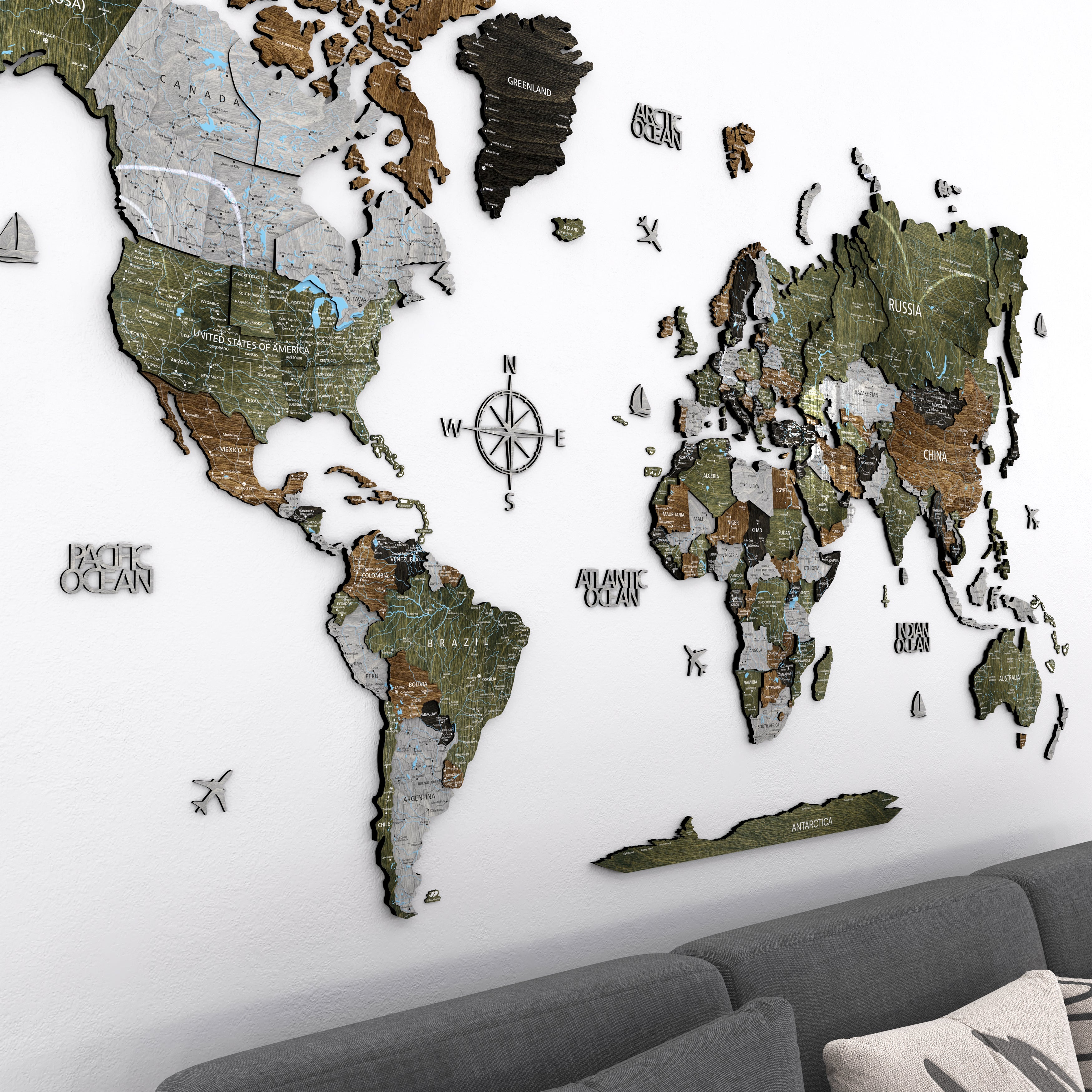 3D Wooden world map wall art on a living room wall featuring a multilayer design in nature-inspired colors.
